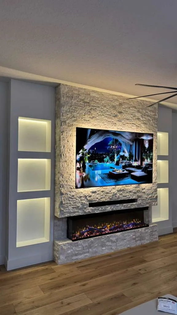 Angled view of the lit niches beside the stone fireplace