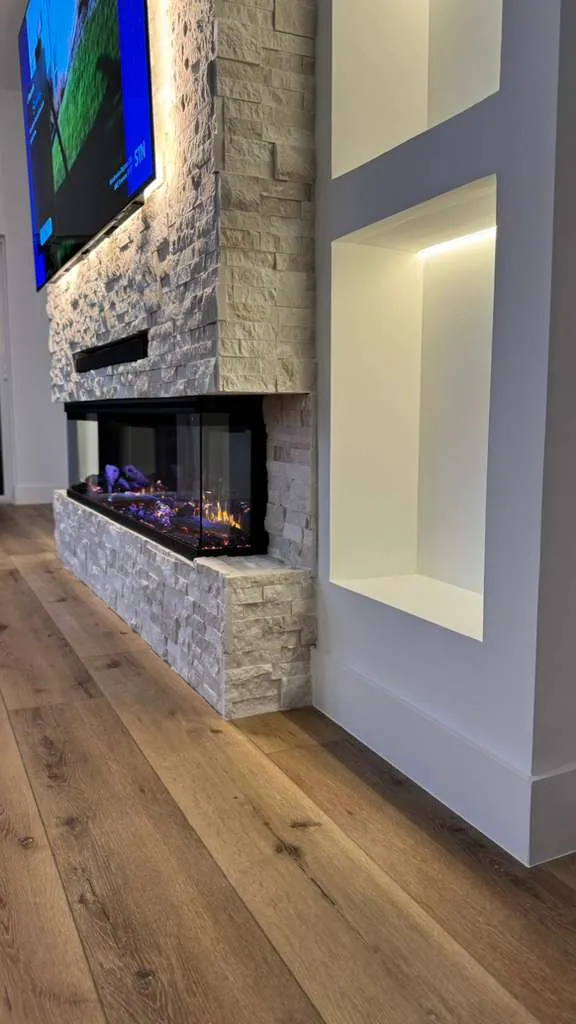 Close-up of the linear fireplace set into stacked stone