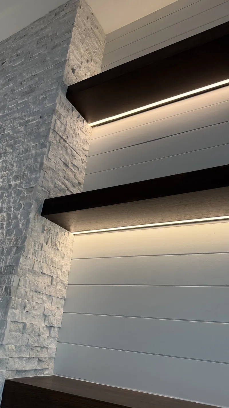 Close view of espresso-tone shelves with LED light underneath