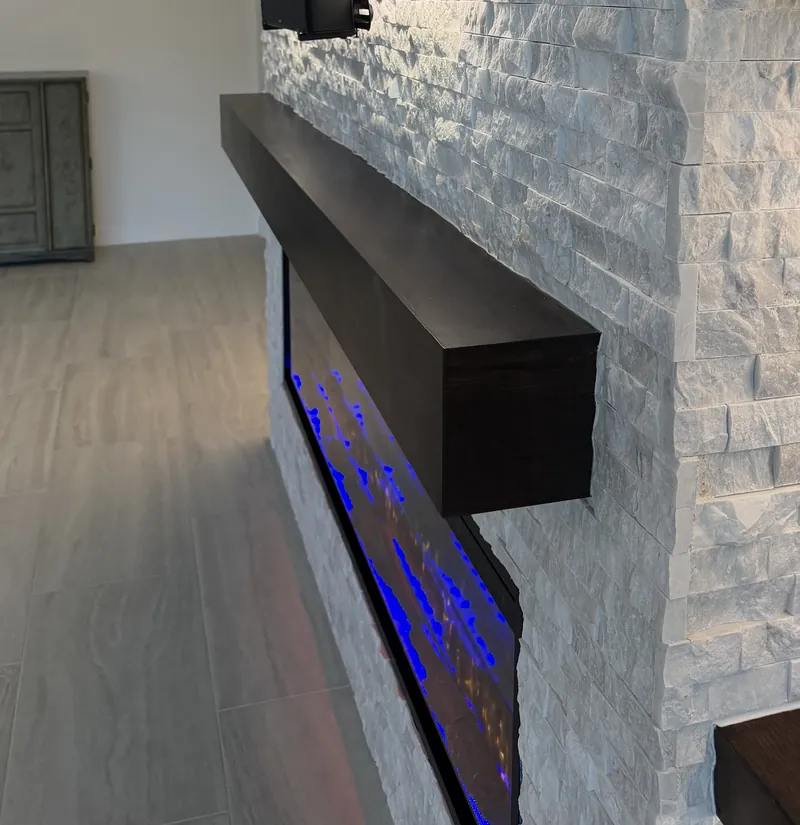 The espresso-tone mantel and the depth of the stone, from the side