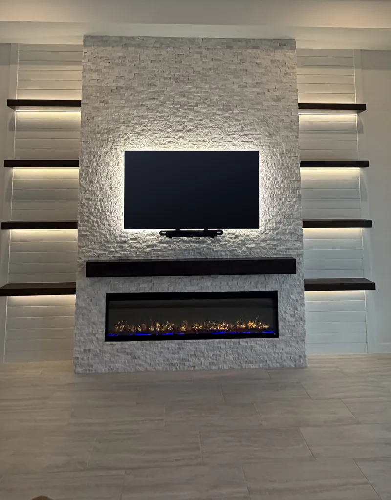 The stone wall dead center, with lit shelves on white shiplap on both sides