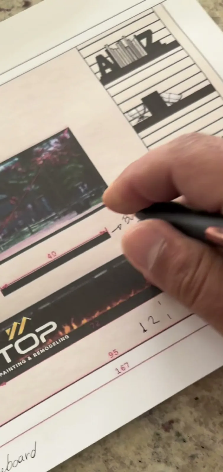A pen marking changes on a printed drawing