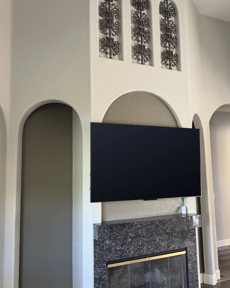 Before: a dark stone surround under the TV, between the arches