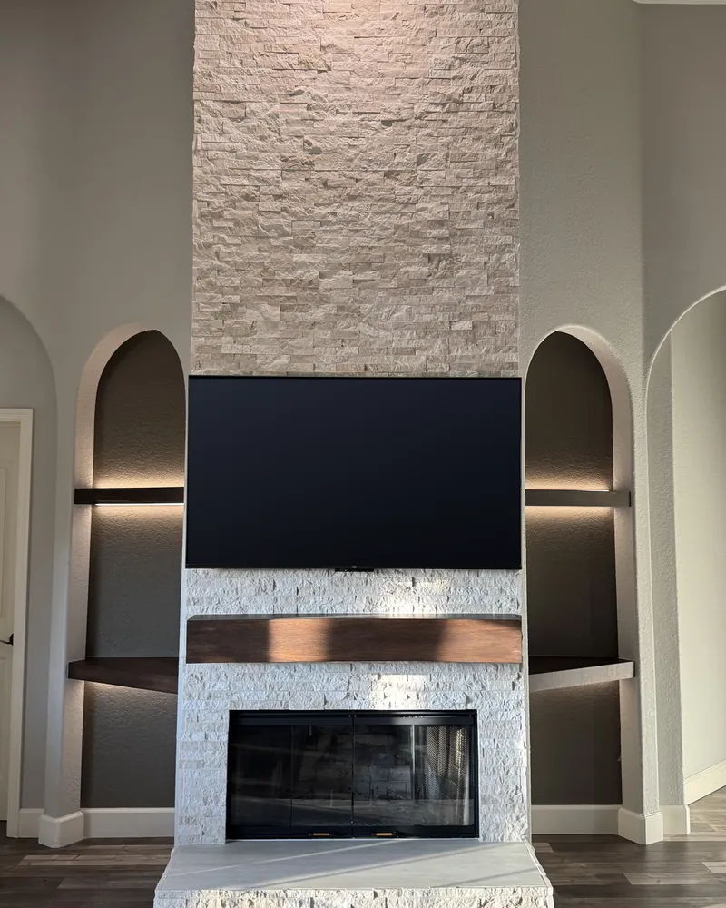 After: stacked stone to the ceiling and lit shelves in the side arches