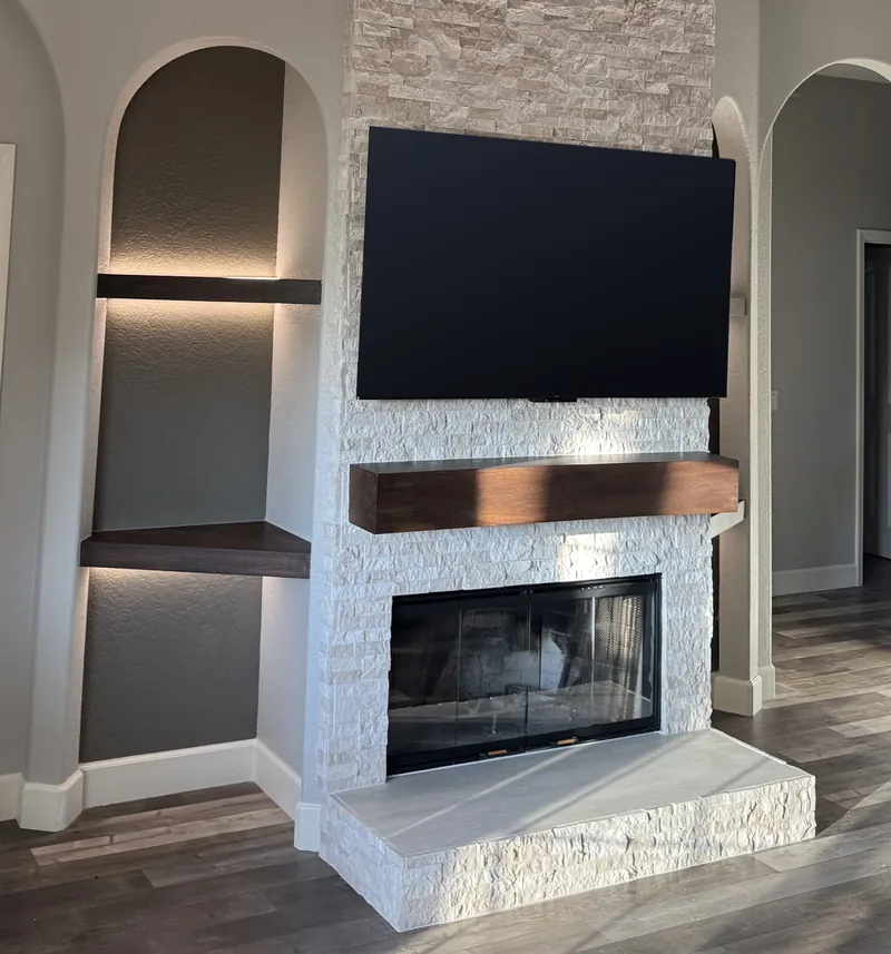 The stone fireplace seen from the side, with one lit arch