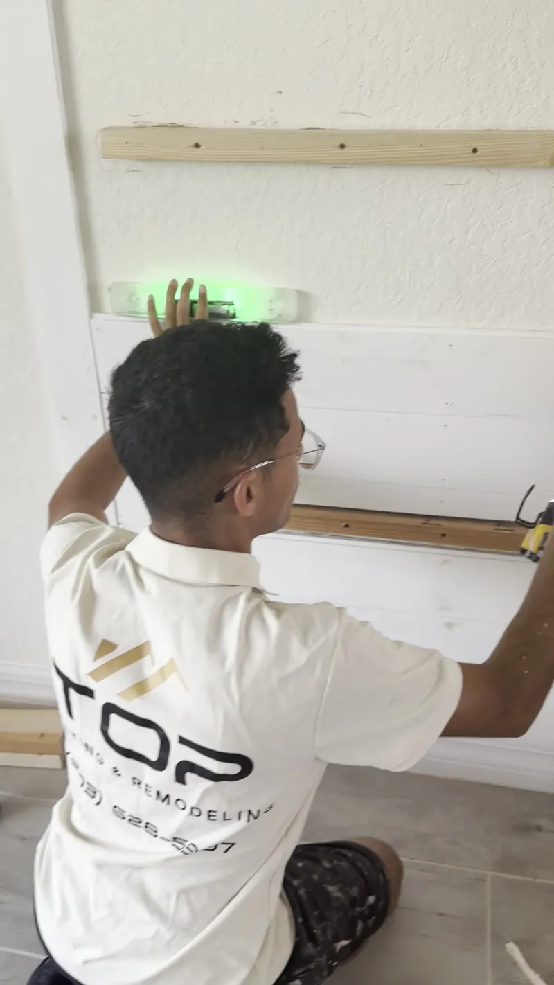 A team member setting level lines with a green laser