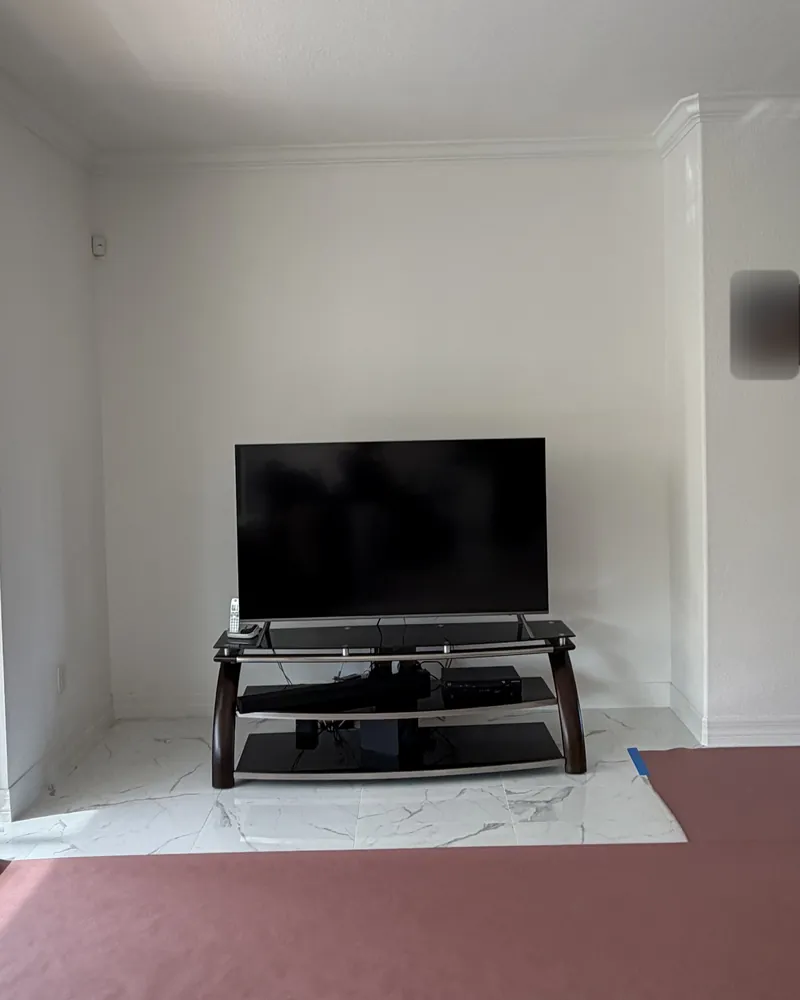 Before: a white wall with a TV on a stand