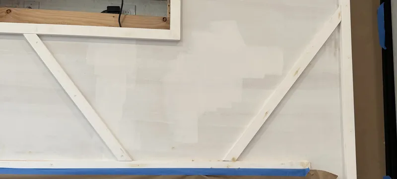 The diagonal trim laid out on the wall before paint