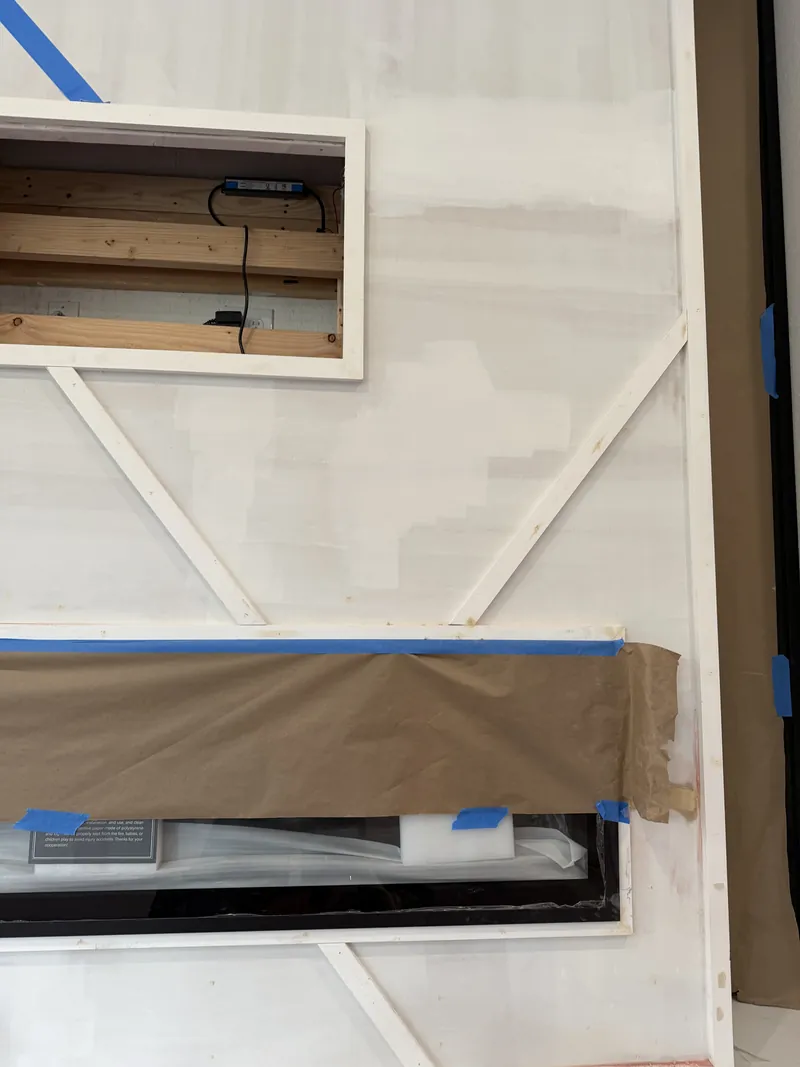 Diagonal trim marked out on a white wall before paint
