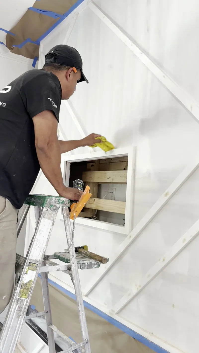 A team member fitting panels and trim by hand