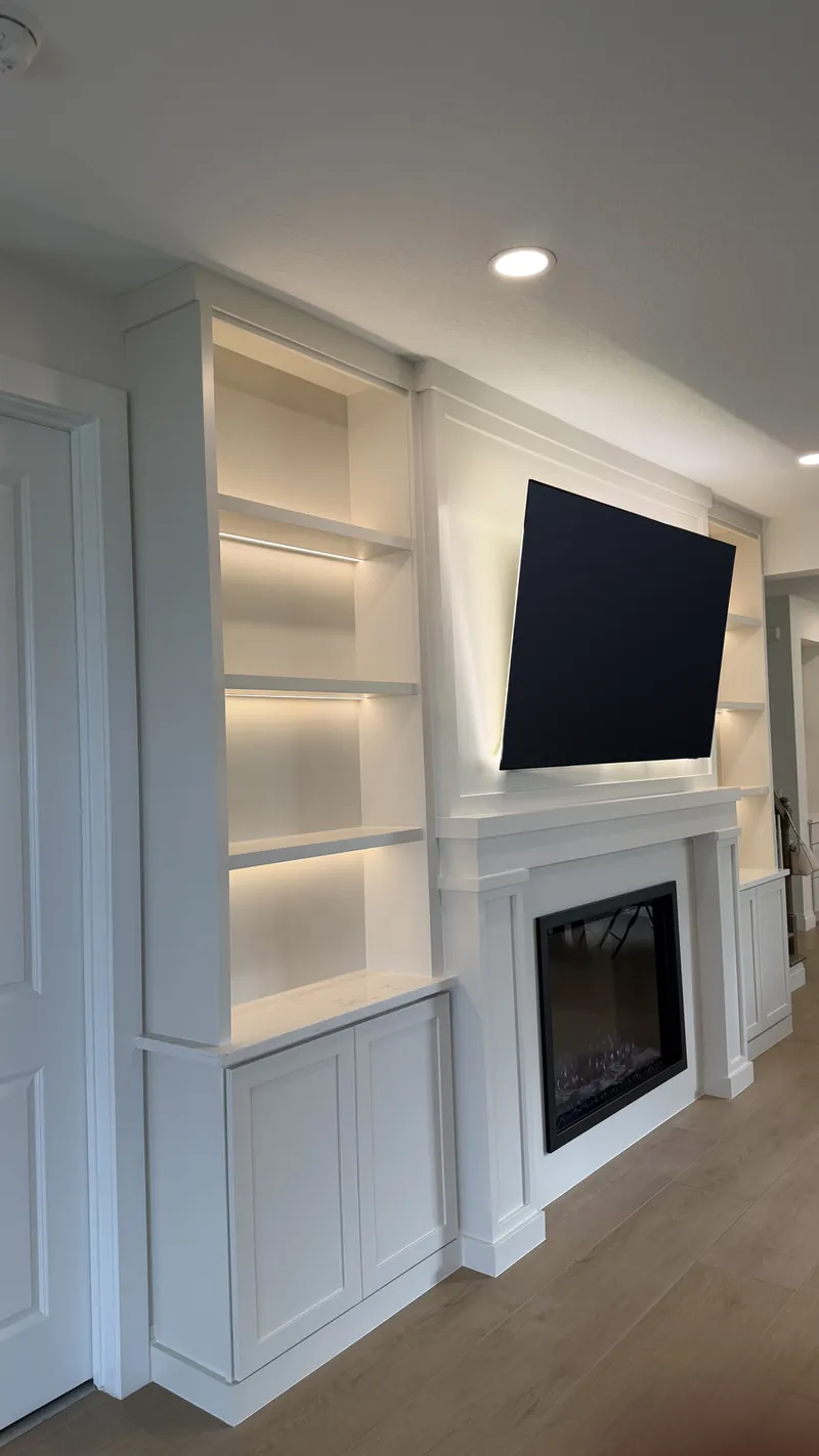 Side view of the white towers, the classic surround and the Shaker cabinets