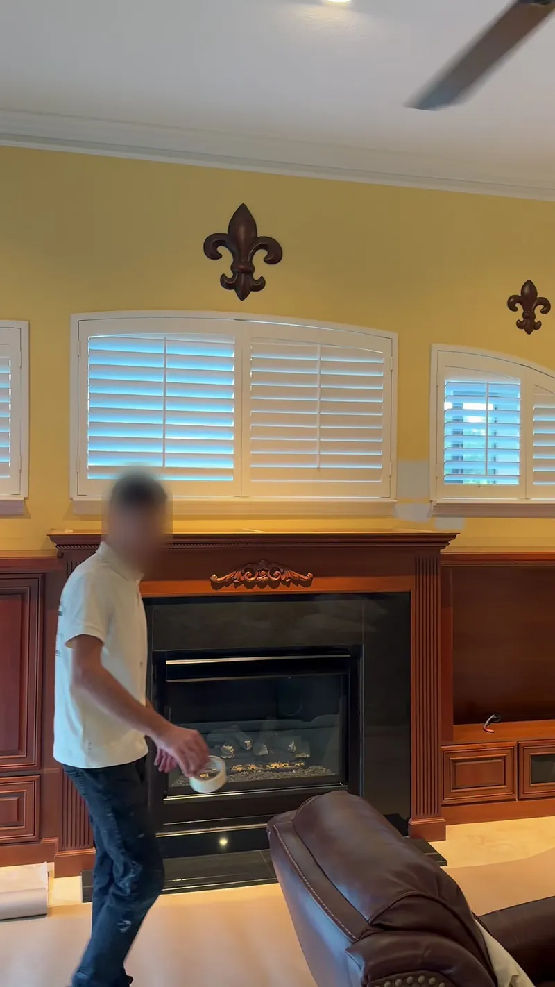 Before: the old wood mantel and fireplace under the same windows