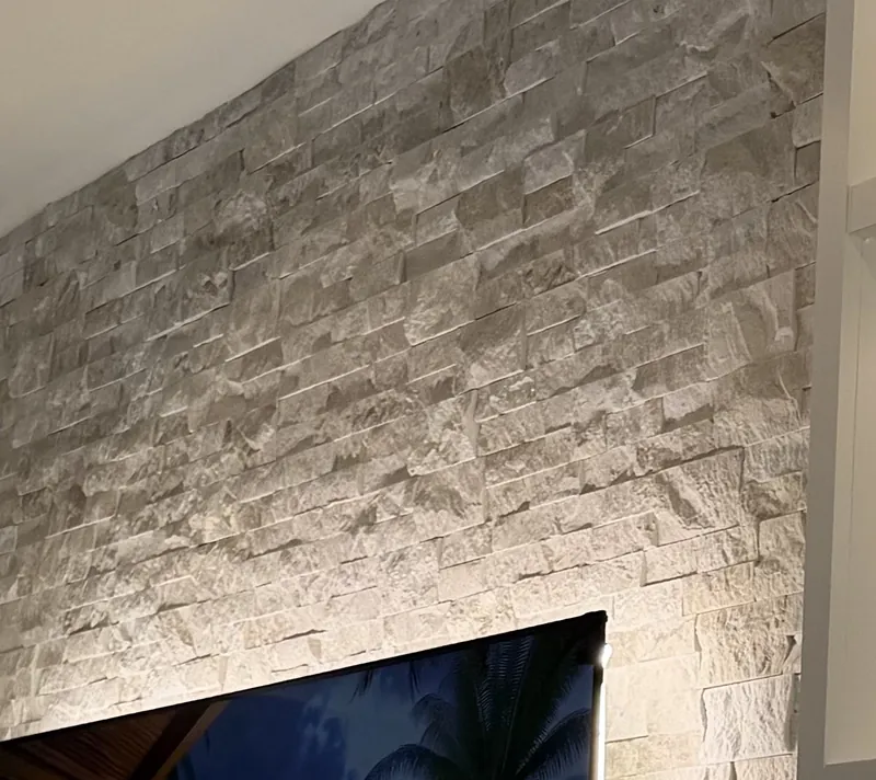 Cream stacked stone lit from behind the TV