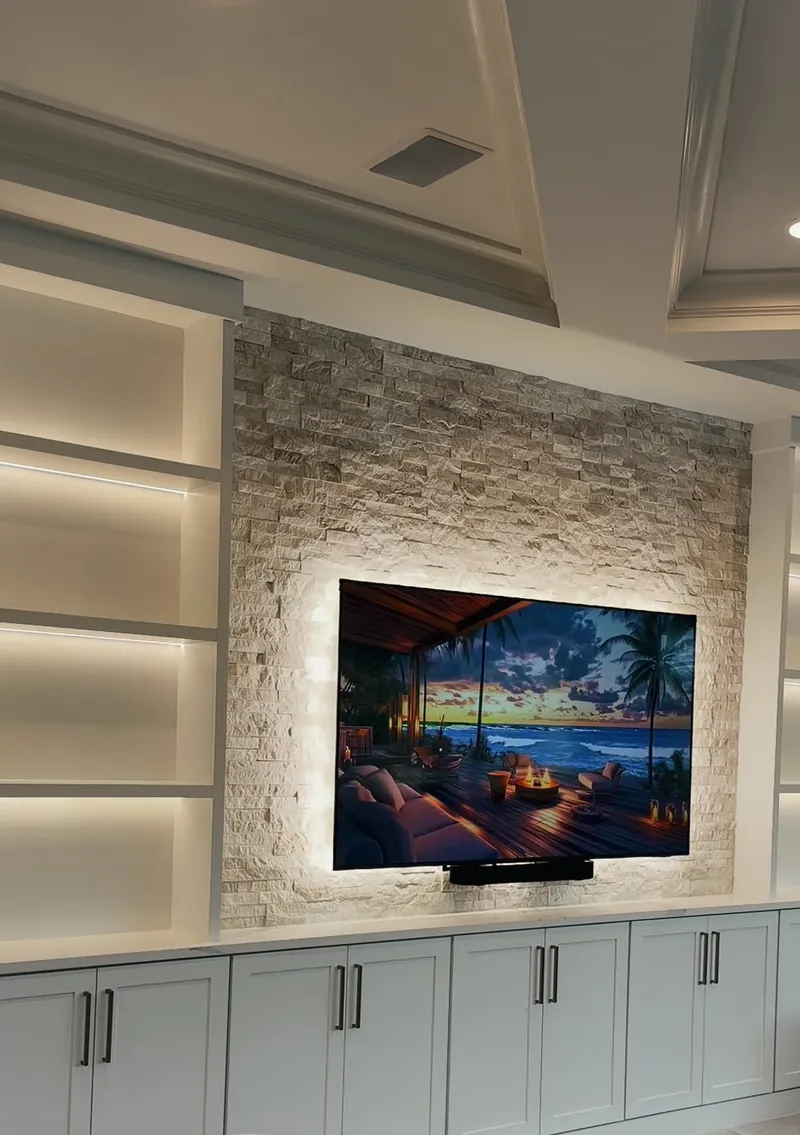 The finished stone TV wall with white lit towers