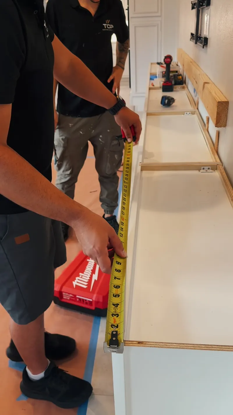 A tape measure along the cabinet run