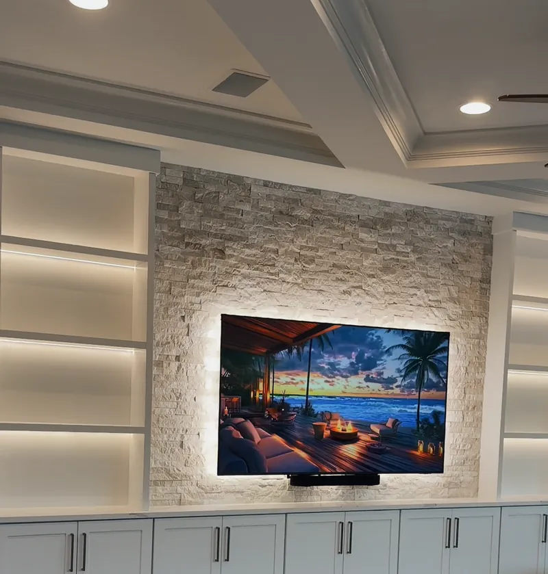 The same wall one press later, with the shelves and the stone lit