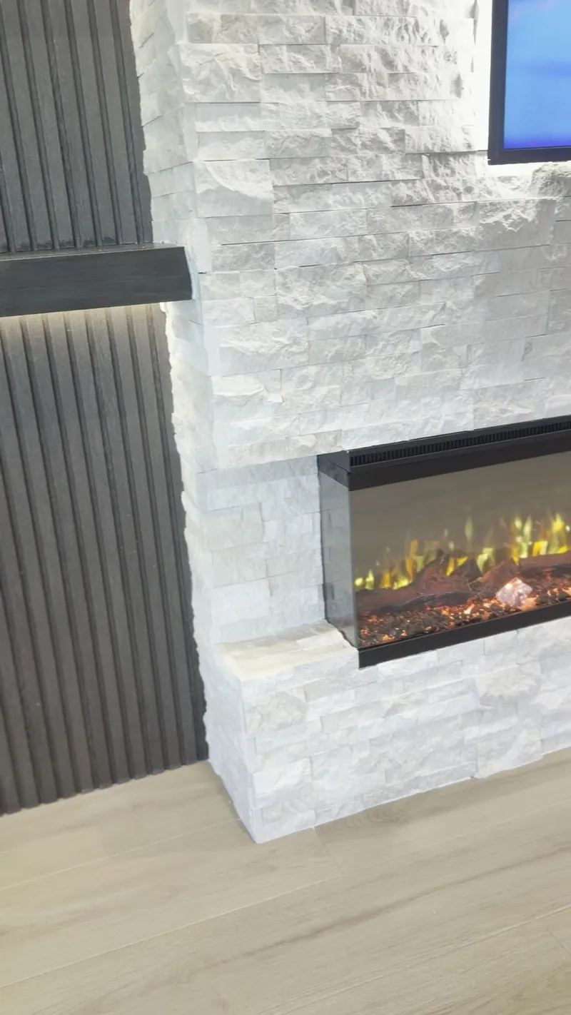 The three-sided fireplace, with glass on the front and on the end