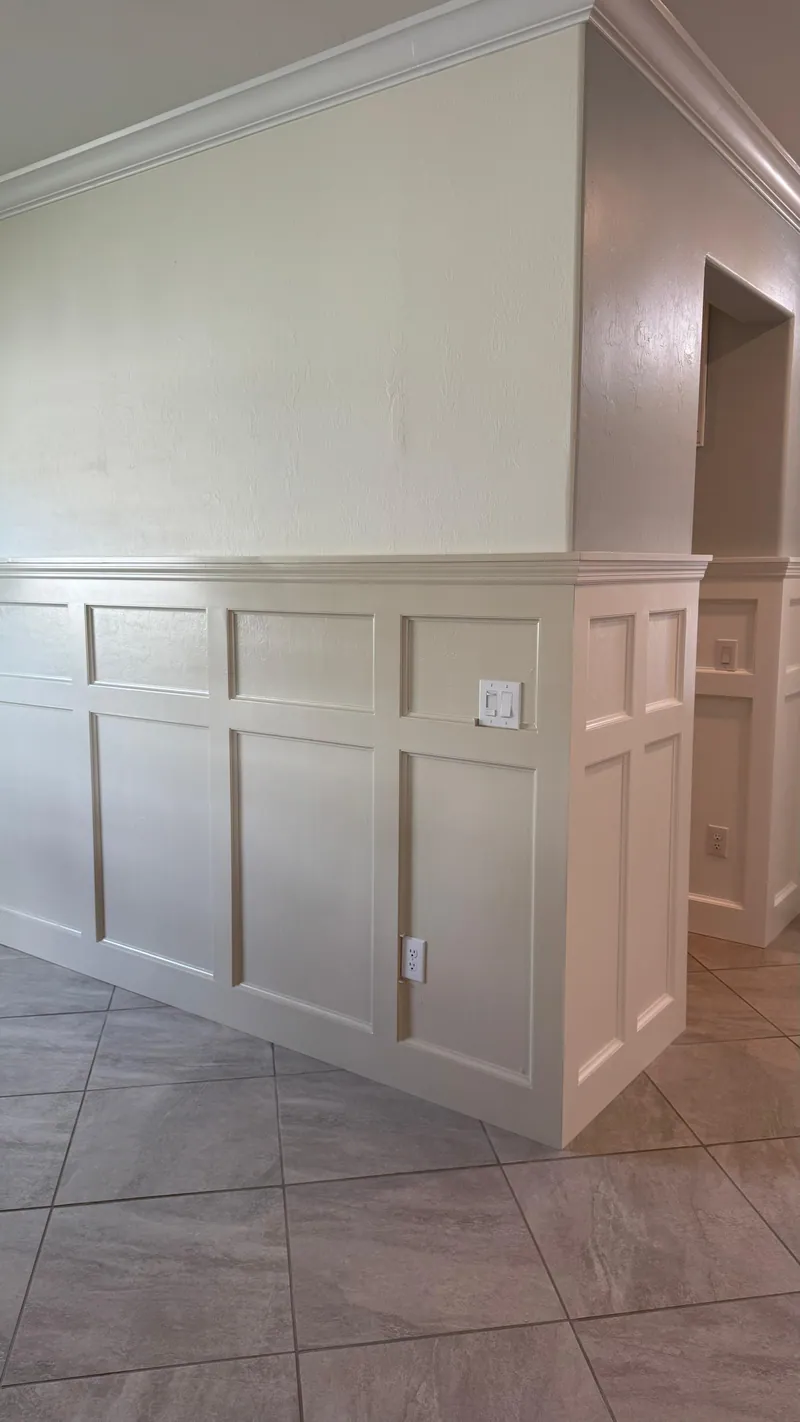 White paneled wainscoting with a chair-rail cap on a half wall